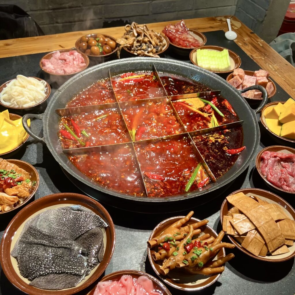 Authentic spicy Chongqing hotpot with beef tallow and chili, a must-try culinary experience.