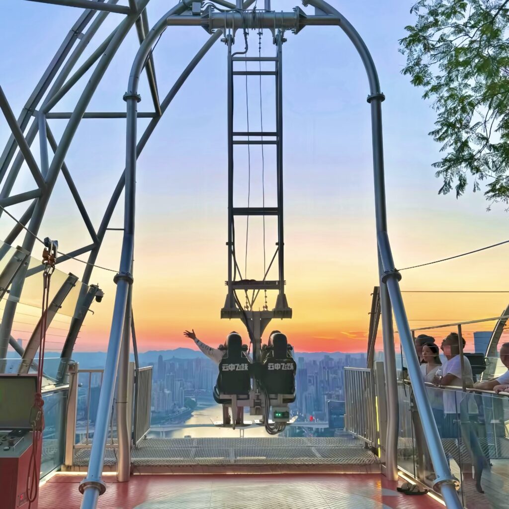 Things to do in Chongqing4 A person swinging on the high-altitude giant swing at Raffles City Chongqing Crystal Skybridge.